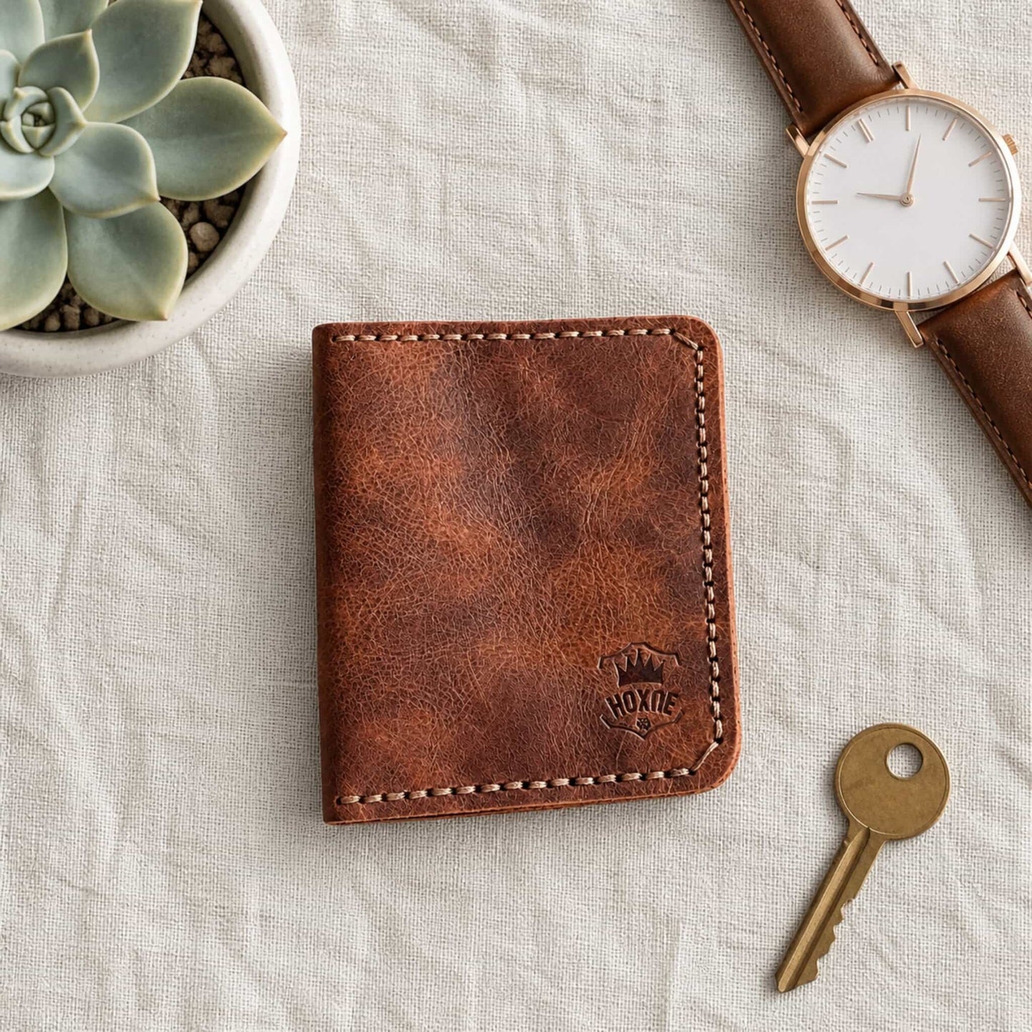 Dark brown genuine leather bifold card wallet with watch and succulents — Hoxne Leather