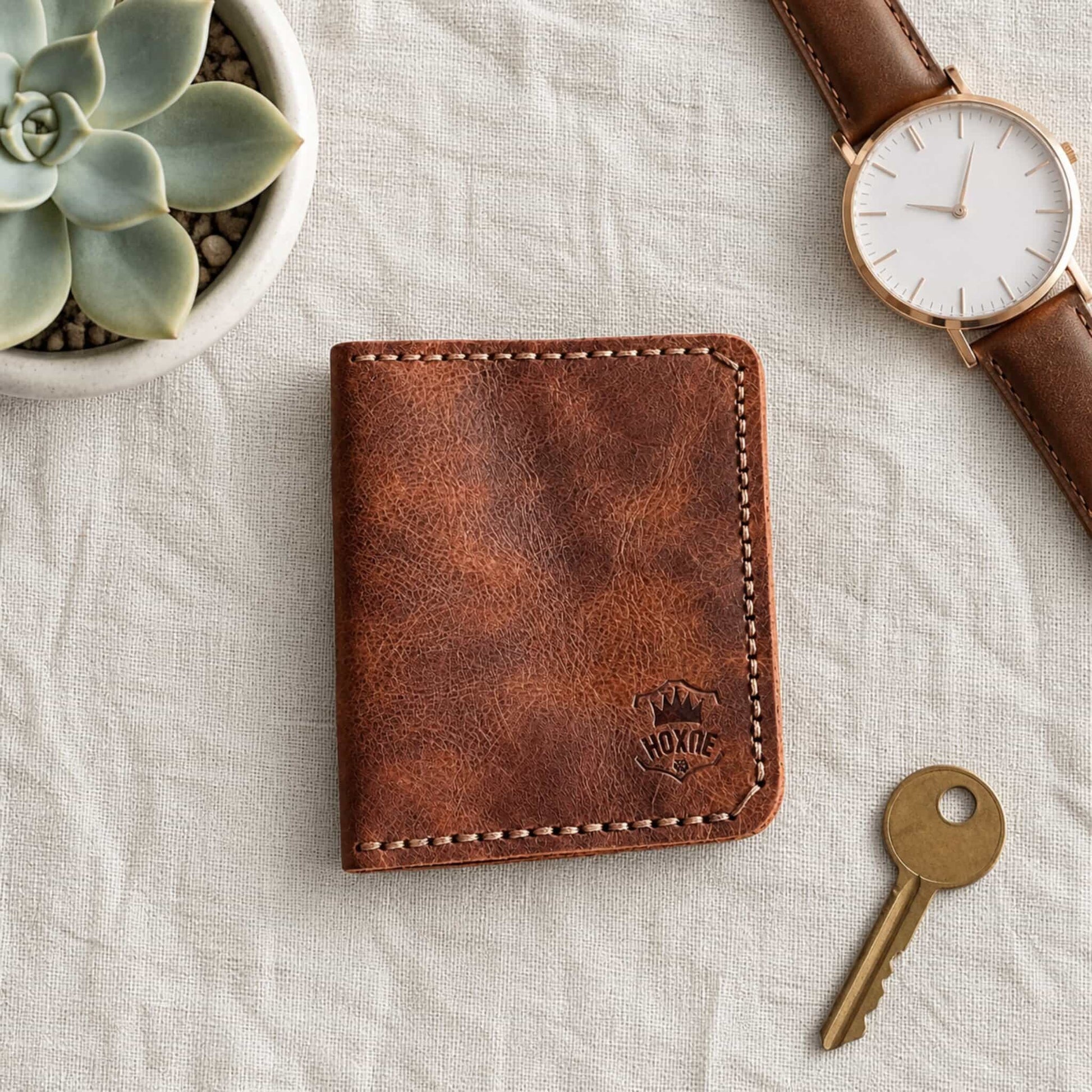 Dark brown genuine leather bifold card wallet with watch and succulents — Hoxne Leather