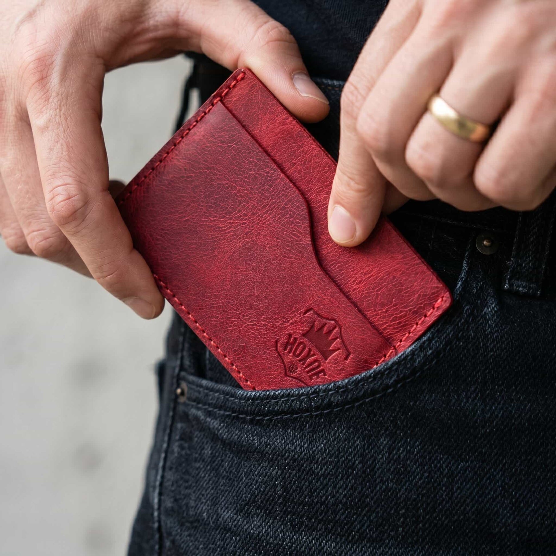Hand holding Hoxne Leather front pocket card wallet, full-grain