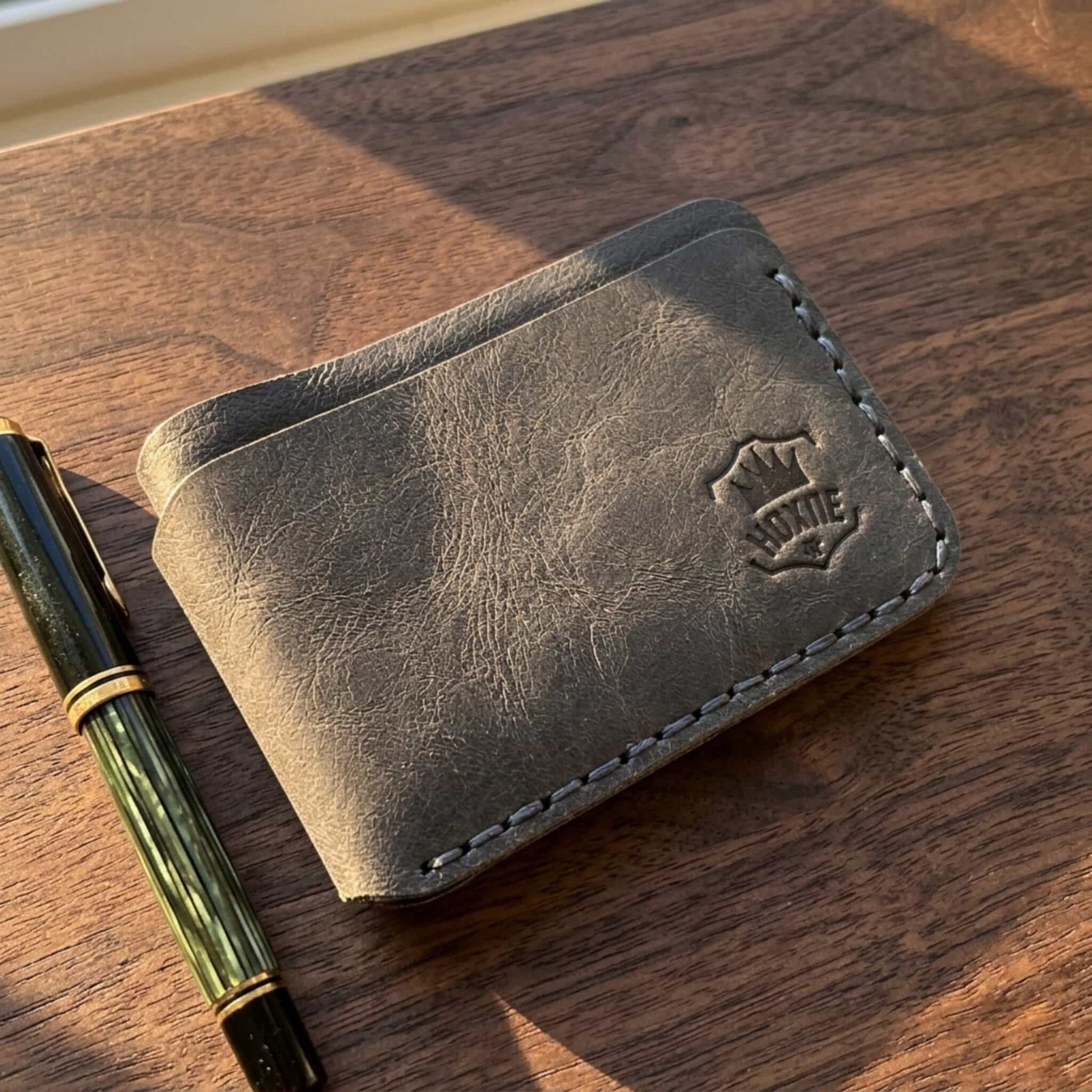Hoxne Leather slim card holder on desk, premium leather goods